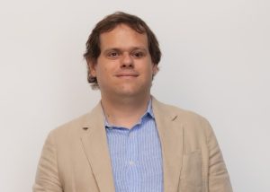 Ignasi Cambri is smiling and wearing a tan jacket.